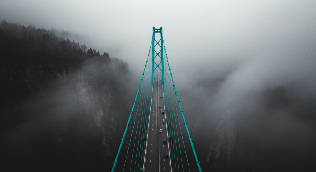 a bridge with cars and fog. impact and alignment